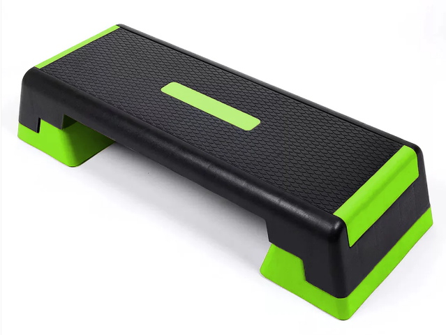 Step platform with black surface and green edges on a white background