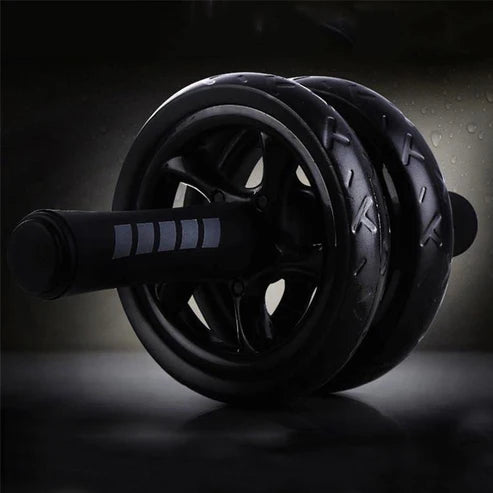 Black exercise wheel on a dark background