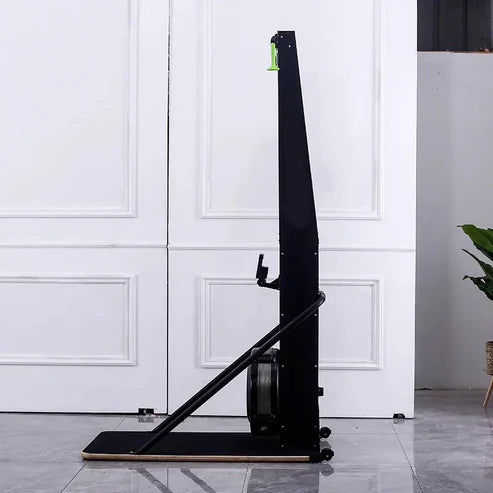Black rowing machine against a white paneled wall.