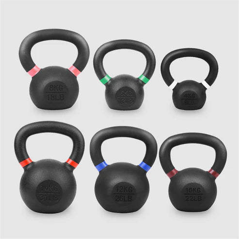 Set of six black kettlebells with color-coded weight markings on a light gray background