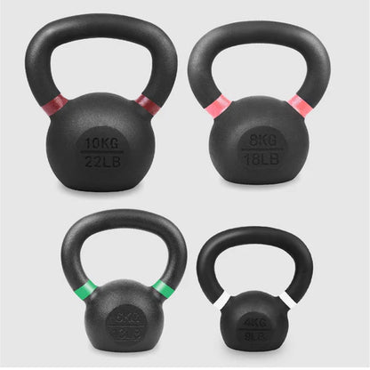 Set of four black kettlebells with weight markings on a light gray background