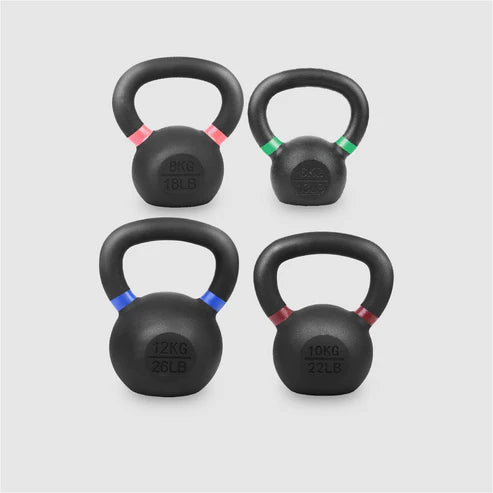 Four black kettlebells with weight markings on a light gray background