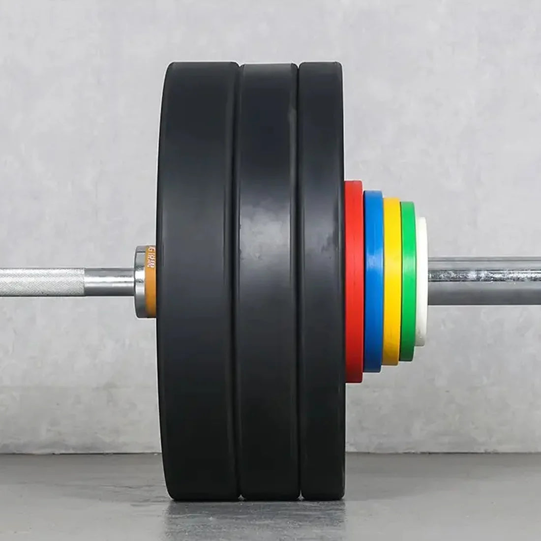 Barbell with weight plates and colorful resistance bands on a gray background