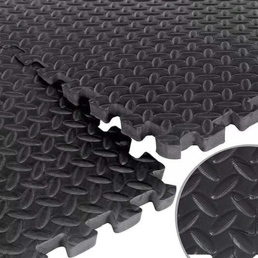 Stack of black interlocking foam mats with textured surface
