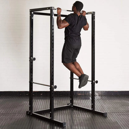 Person using a power rack in a gym setting