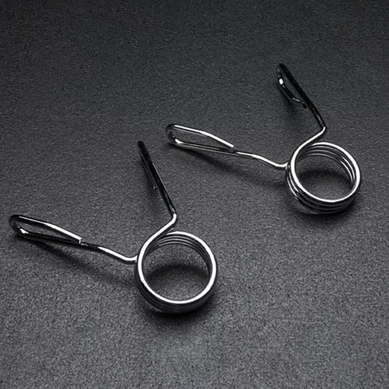 Two metal spring-loaded fishing line holders on a dark gray background