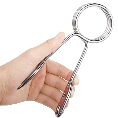 Hand holding a silver metal object against a white background