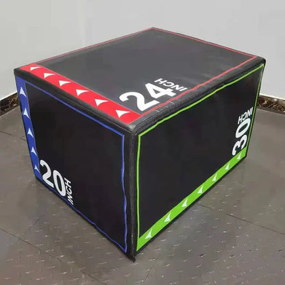 Black exercise cube with colorful side panels and measurement labels on a gray floor.