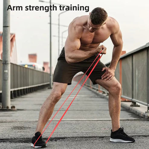 Man exercising with resistance bands on a bridge