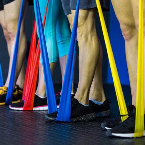 Group of people exercising with resistance bands in a gym setting