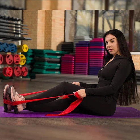 Woman exercising with resistance bands in a gym setting