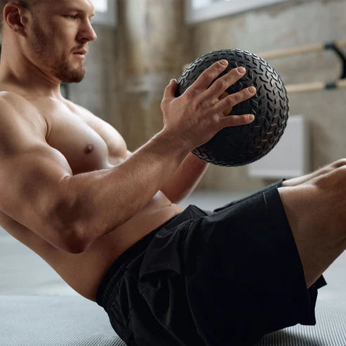 Man exercising with a medicine ball in a home setting