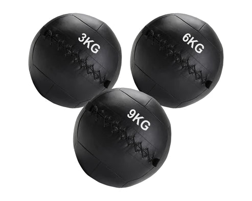 Three black weighted medicine balls with different weights on a white background