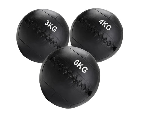 Three black weighted medicine balls with weight markings on a white background