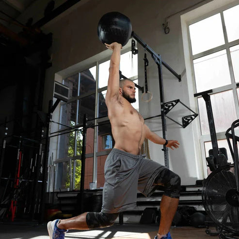 Man exercising with a medicine ball in a gym setting