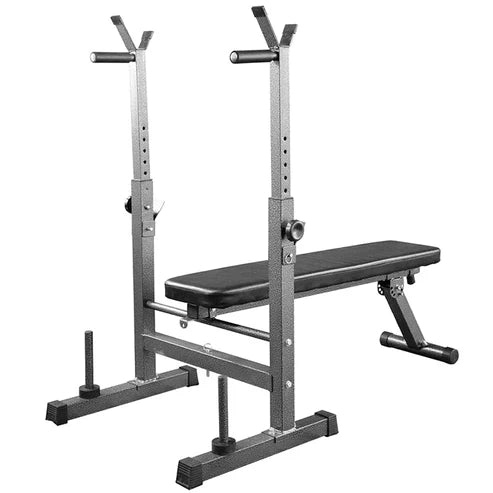 Black weight bench with adjustable stands on a wooden floor, plant in the background.