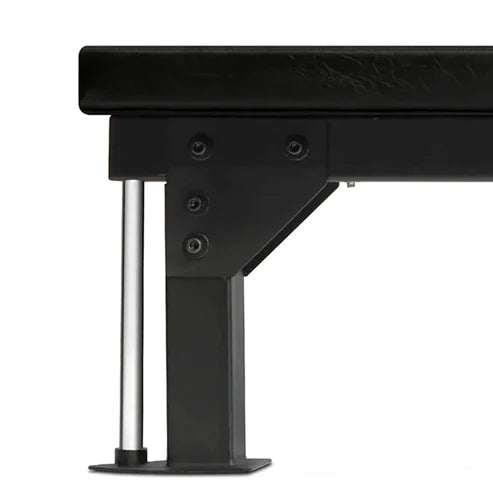 Close-up of a black metal bench with a white background