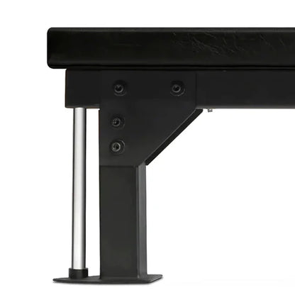 Close-up of a black metal bench with a white background