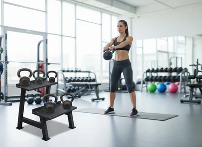 Woman exercising with kettlebells in a gym setting